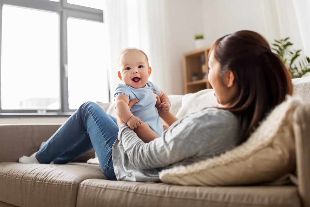 happy mother with little baby son at home